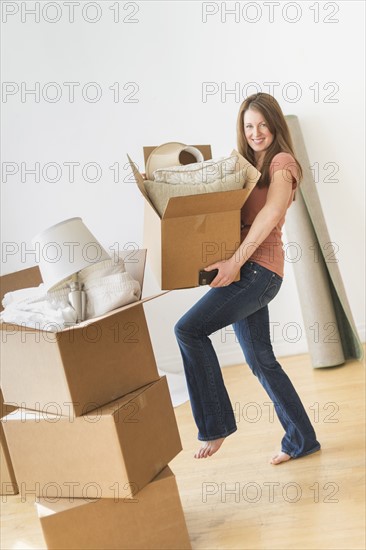 Portrait of woman moving in to new house.