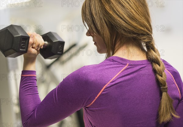 Portrait of woman weightlifting.