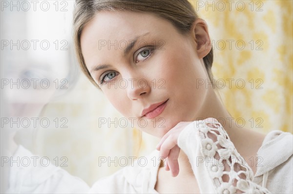 Portrait of young woman by window.