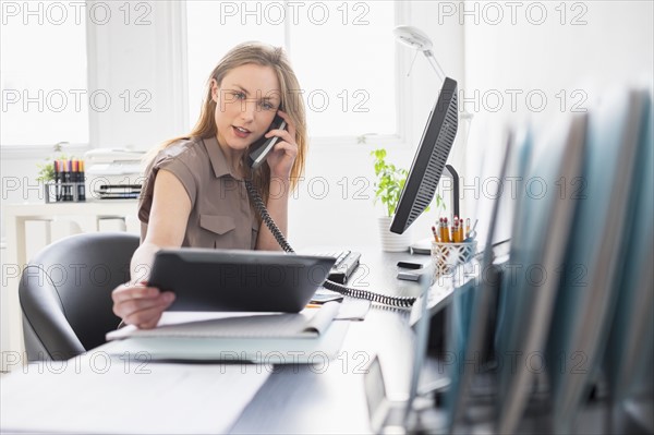 Portrait of young woman working in office.