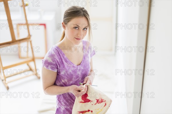 Portrait of female artist in studio.