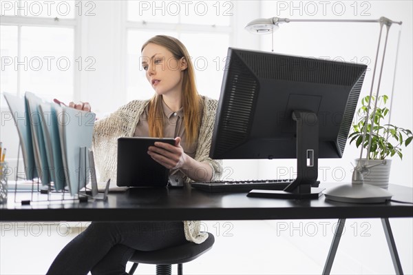 Portrait of young woman working in office.