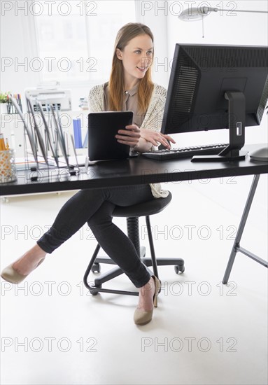 Portrait of young woman working in office.