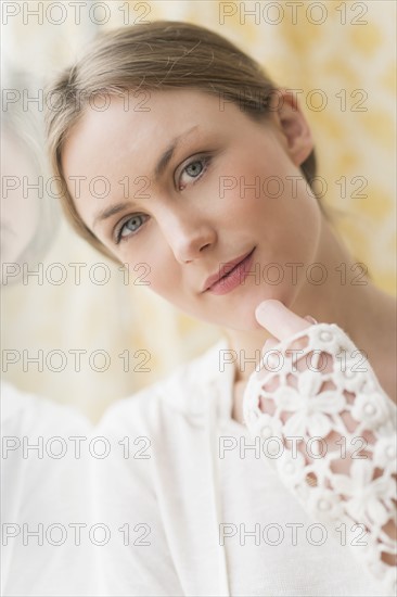 Portrait of blond woman by window.