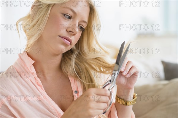 Portrait of young woman cutting hair.
Photo : Jamie Grill