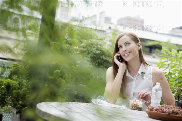 Portrait of young woman sitting on balcony and using mobile phone. New York City, USA.
Photo : pauline st.denis