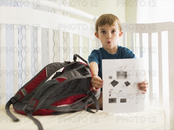 Boy (8-9) showing his homework.
Photo : Jessica Peterson