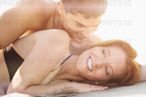 View of couple lying on beach.