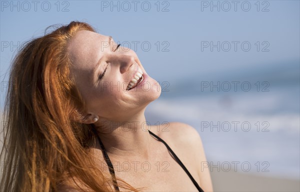 Woman on beach suntanning.