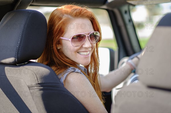 Portrait of woman sitting in car.