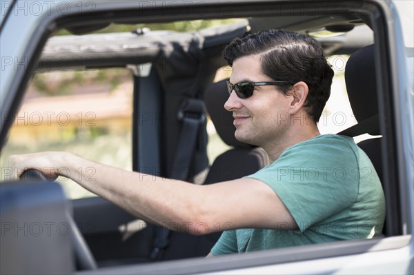 View of man driving car.