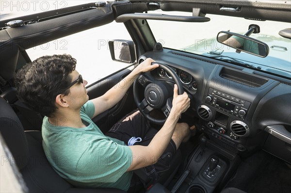 Elevated view of man driving car.