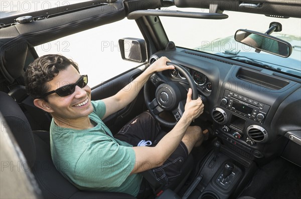 Elevated view of man driving car.