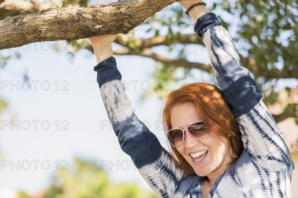 Portrait of woman holding branch.