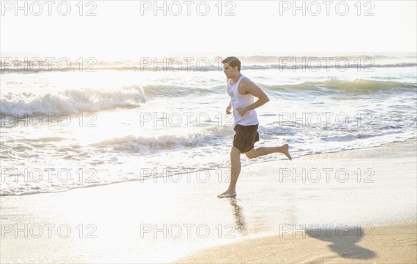 Man running on beach.