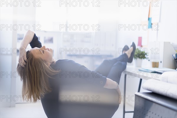 Business woman relaxing in office.