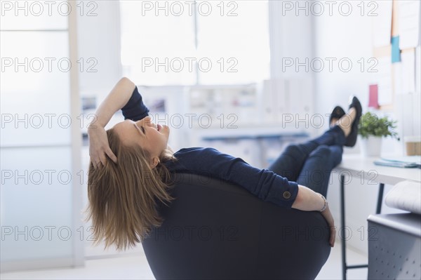 Business woman relaxing in office.