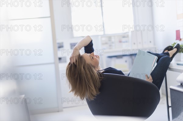 Business woman relaxing in office.