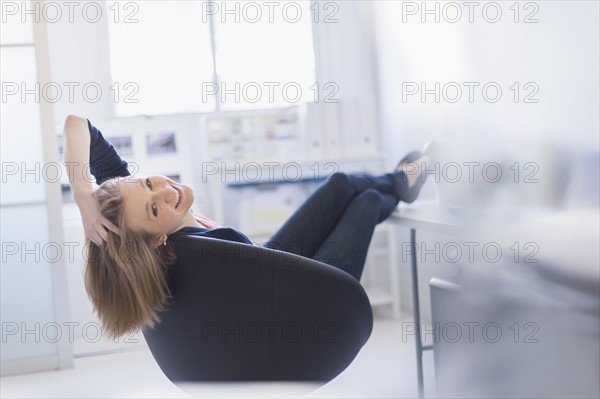 Business woman relaxing in office.