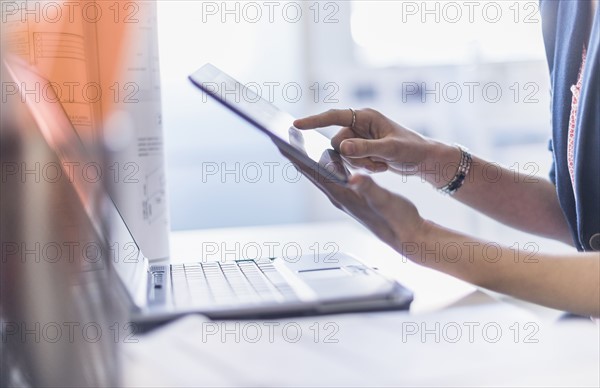 Close up of hands holding digital tablet.
