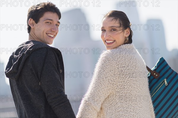 Portrait of young couple walking.