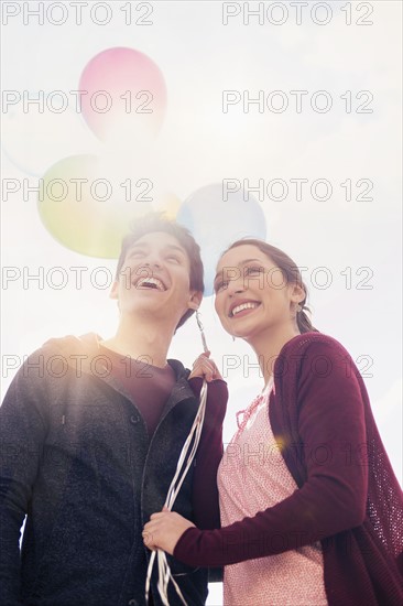 Young couple with balloons.