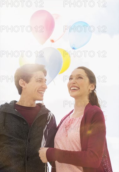 Young couple with balloons.