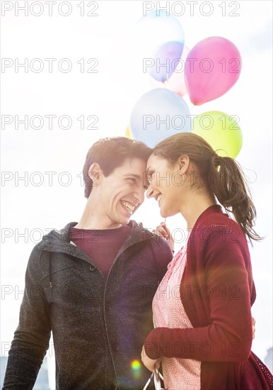 Young couple with balloons.