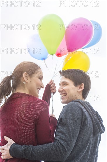 Young couple with balloons.