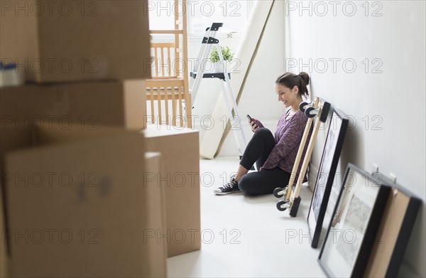 Young woman moving into new flat.