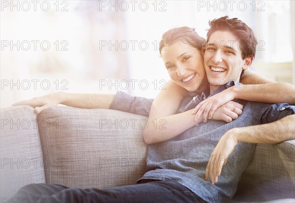 Woman embracing man at home.