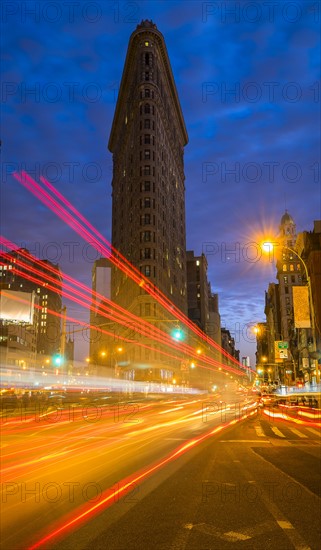 Traffic at night, Flatiron building in background.