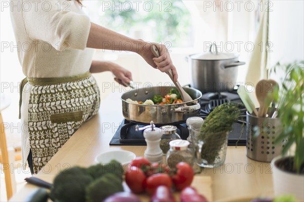 Woman cooking in kitchen.