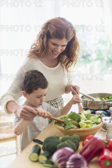 Mother and son (6-7) cooking together.