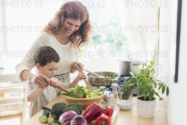 Mother and son (6-7) cooking together.