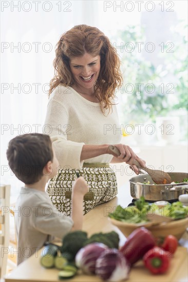 Mother and son (6-7) cooking together.