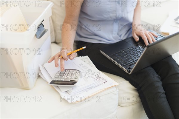 Woman paying bills via internet.