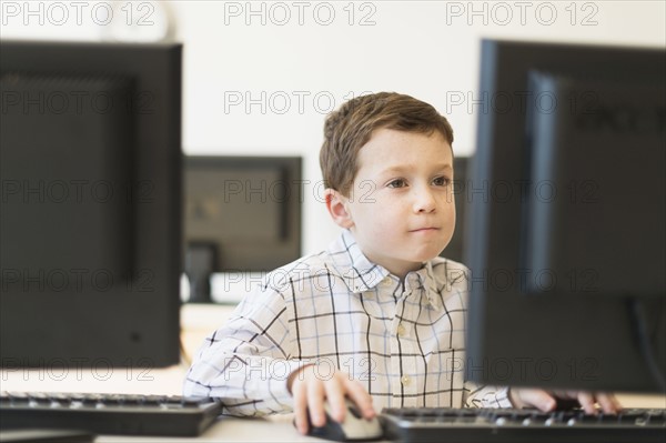 boy (6-7) using computer.