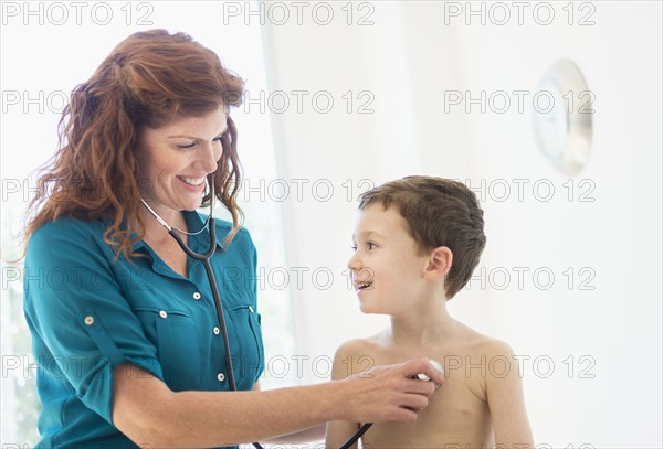 boy (6-7) undergoing medical exam.