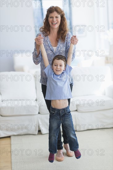 Mother and son (6-7) playing in living room.