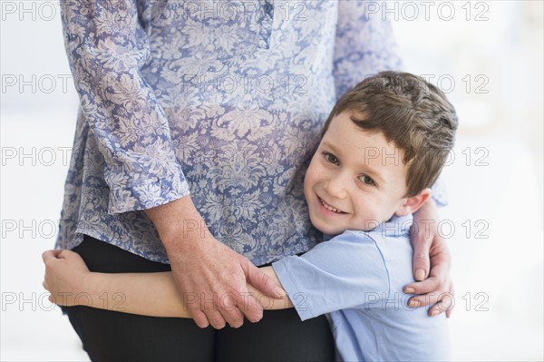 boy (6-7) embracing mother.