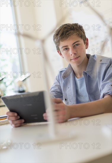 Teenage boy (16-17) using digital tablet in laboratory.