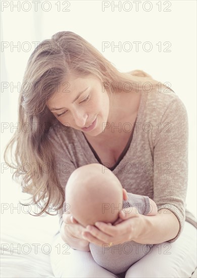 Mother holding baby boy (2-5 months).