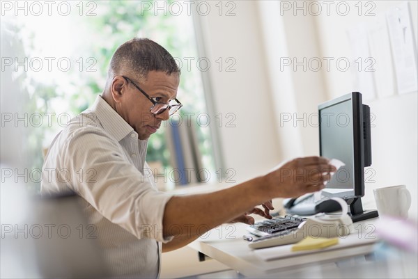 Mature man working in home office.