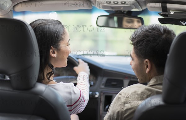 Young couple traveling in car.