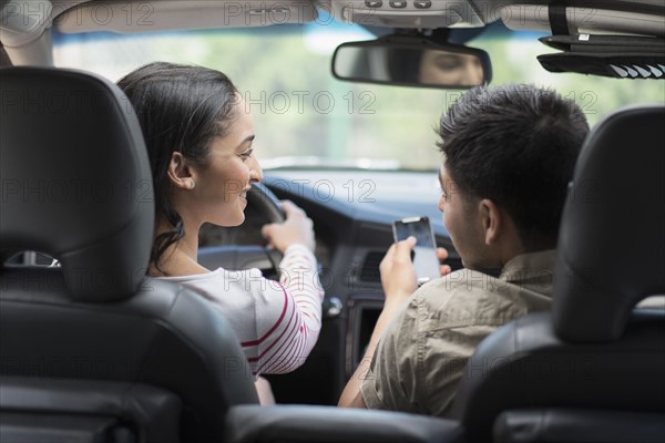 Young couple traveling in car.