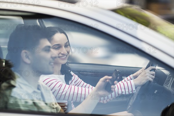 Young couple traveling in car.