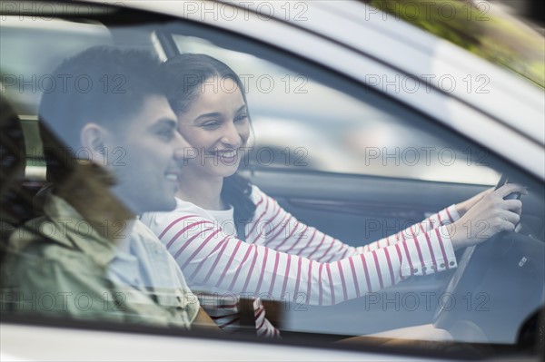 Young couple traveling in car.