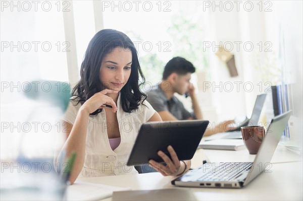 Young woman and man working in office.