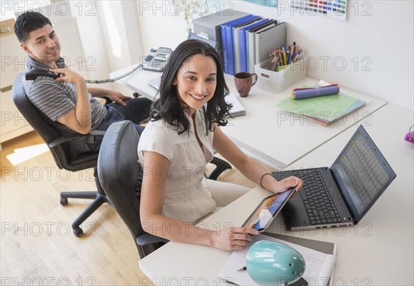 Young woman and man working in office.